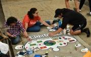 Students from the 全球 Student Friendship Center paint international flags on their crown. 图Chuck Thomas/ODU