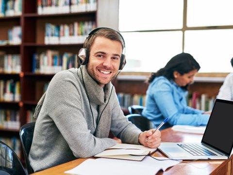 Student working in library at university